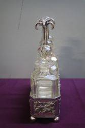 Antique Victorian Cut Glass 3 Bottle Tantalus in a Silver Plated 