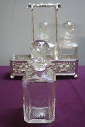 Antique Victorian Cut Glass 3 Bottle Tantalus in a Silver Plated 