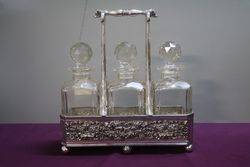 Antique Victorian Cut Glass 3 Bottle Tantalus in a Silver Plated 