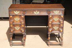 A Small Early C20th 7 Drawer Oak Desk. #