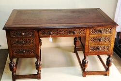 Early C20th Carved Oak 7 Drawer Writing Desk