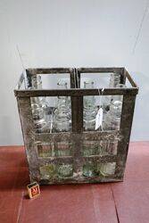 8 Vintage Embossed Essolube Oil Bottles in Original Crate.