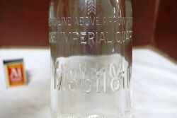 Embossed Mobiloil 1 quart Bottle and Tin Top