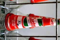 Vintage Castrol Embossed 6 Bottle Rack with Tin Tops